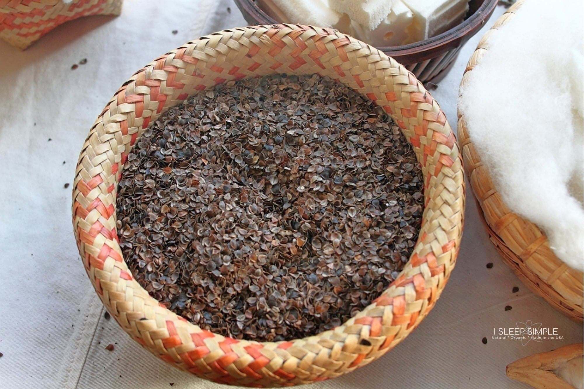 Organic buckwheat hulls in a woven basket, ideal for pillows and cushions, promoting comfort and airflow.