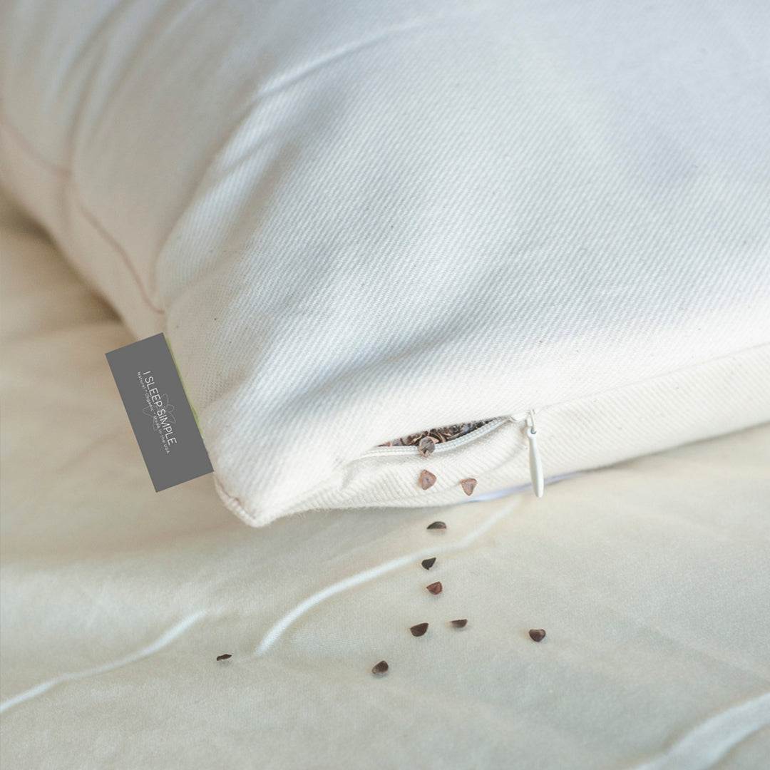 Organic buckwheat pillow with adjustable loft and firmness, designed for ergonomic support and breathability.