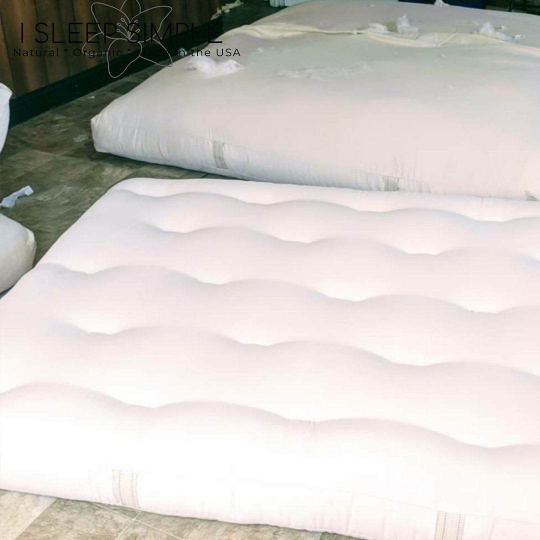 GOTS certified organic cotton and wool futon mattress displayed on a floor, showcasing its natural and toxin-free materials.